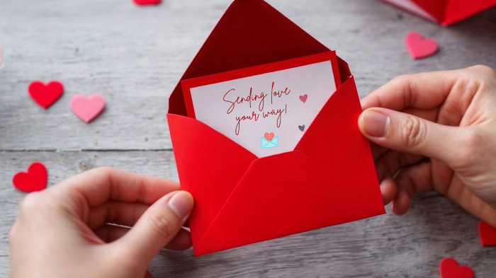 A tiny envelope carefully glued onto a card, holding a handwritten love letter for a heartfelt surprise.