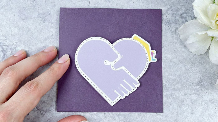 A traced outline of your arms, folded to “hug” the recipient when they open it, for a warm and interactive surprise.