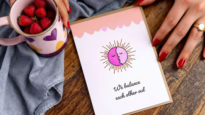 A beautifully illustrated sun and moon with the caption “We balance each other out,” representing harmony and opposites attracting.