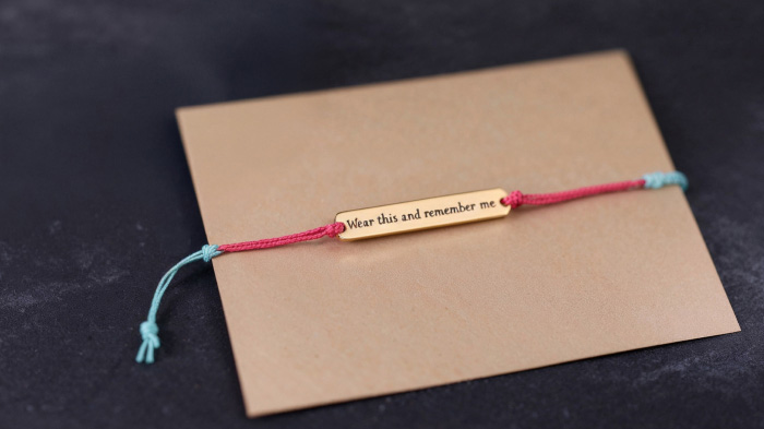 A simple yet meaningful bracelet attached with the note, “Wear this and remember me,” symbolizing unbreakable friendship.