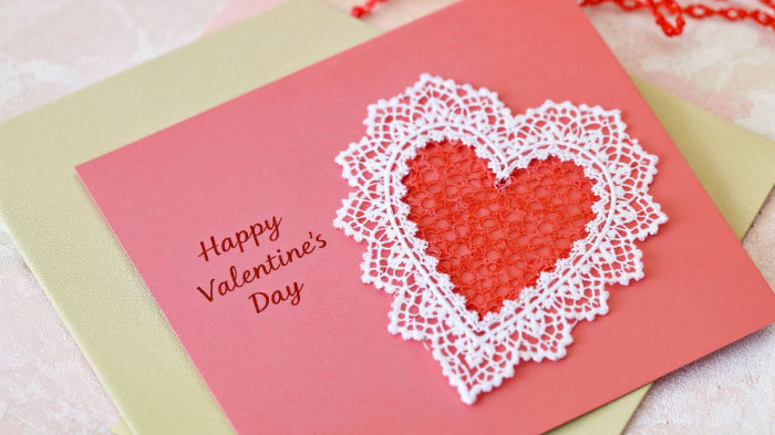 A Valentine’s card decorated with soft lace trim, giving it a delicate and vintage-inspired look.