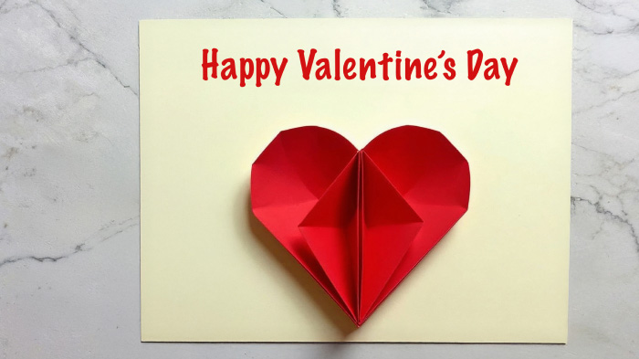 A folded paper heart carefully attached to the card, creating a dimensional effect that stands out beautifully.