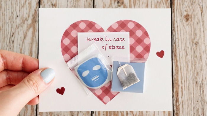 A survival-themed card with a taped-on tea bag or face mask, labeled “Break in case of stress,” for self-care and love.