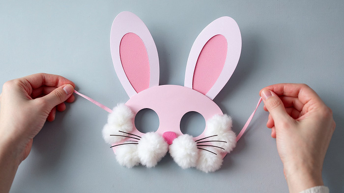 Handmade bunny mask card with cotton ball details and elastic bands.