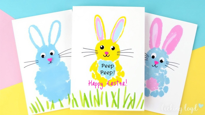 Fingerpainted yellow chicks with hand-drawn details on a card.