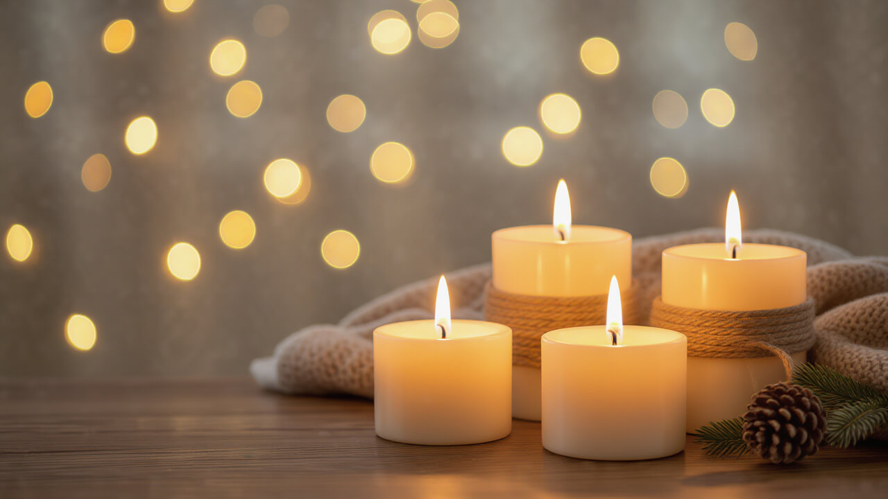 Glowing candles on a wooden table with warm light and cozy ambience — perfect banner for candle photography ideas.
